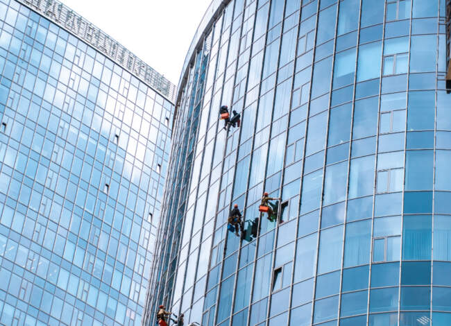 Workers Washing Windows Office Building